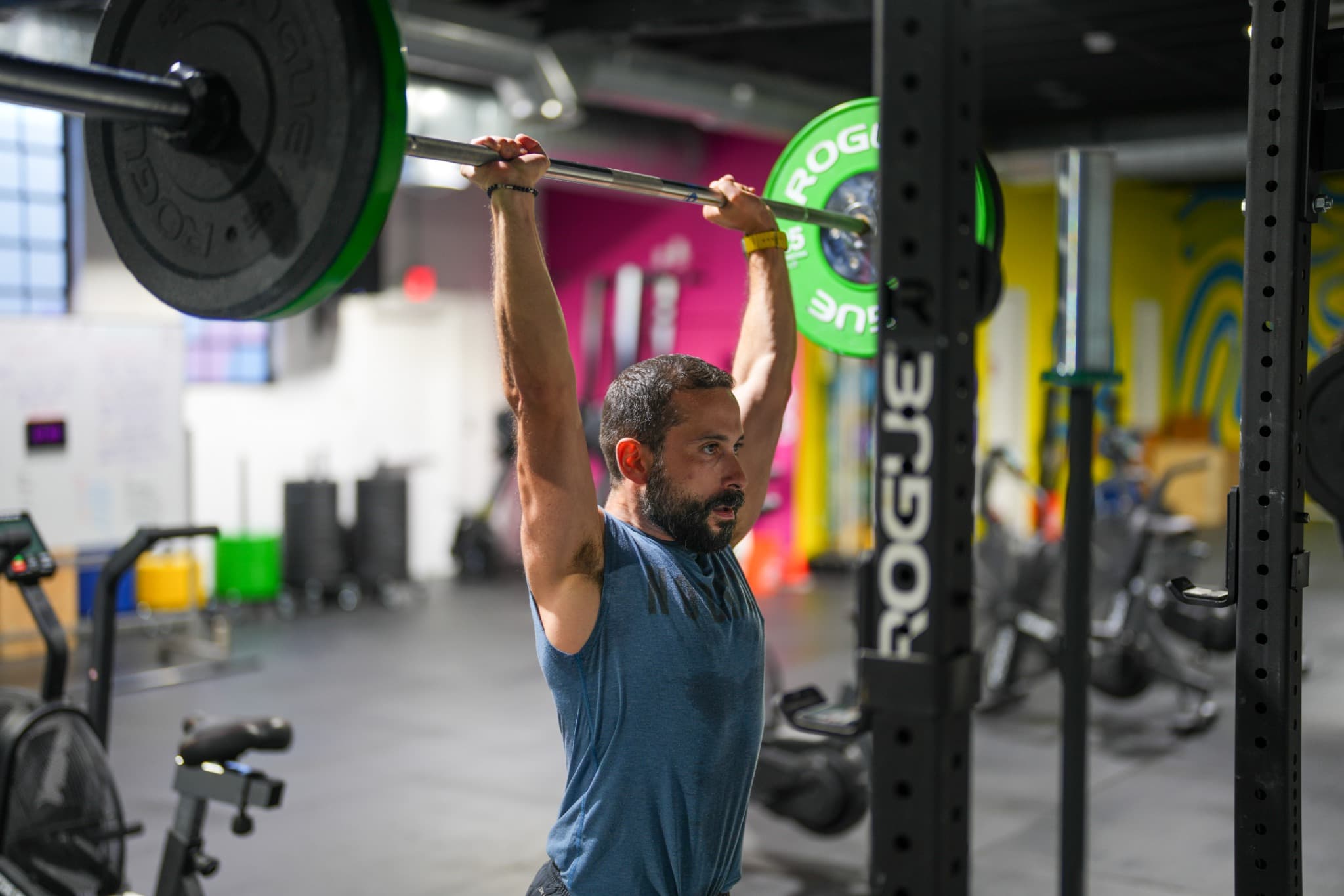 Athlete performing an overhead barbell lift at Wynwood Fitness Club, Miami