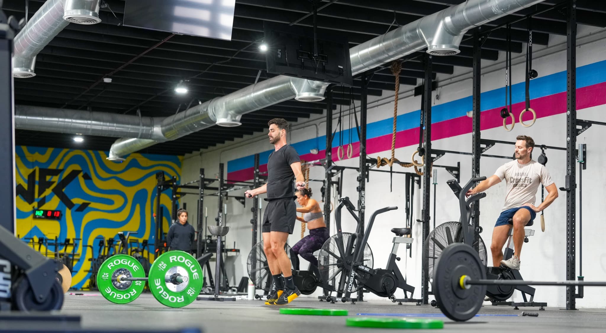 Coach giving hands-on individualized coaching at Wynwood Fitness Club, Miami